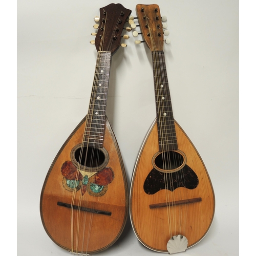 131 - Two mandolins, one with inlaid decoration of a butterfly, the other with plain mahogany back