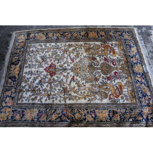 14 - Wool machine made rug in Persian pattern, decorated with birds and flowers on a beige ground, 172 x ... 