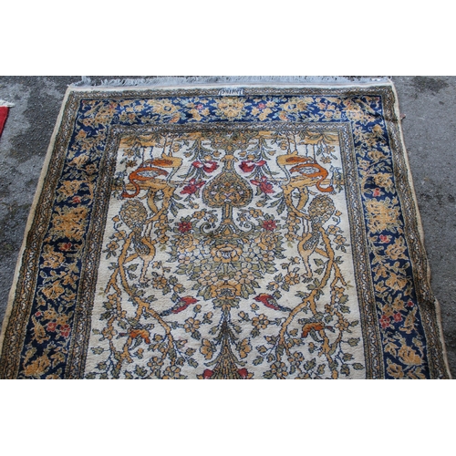 14 - Wool machine made rug in Persian pattern, decorated with birds and flowers on a beige ground, 172 x ... 