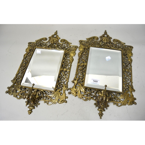 1425 - Pair of late 19th Century pierced brass wall mirrors with maskhead surmounts and bevelled plates