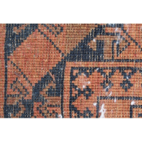 15 - Afghan rug with two rows of five gols on a red ground, 182 x 125cm