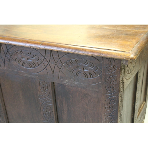 1664 - 18th Century oak four panel coffer with carved decoration on stile end supports, 133cm x 59cm x 63cm... 