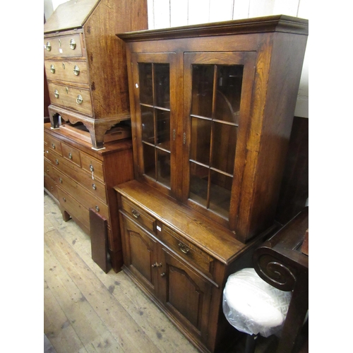 1665 - Reproduction oak bookcase with a moulded cornice above a pair of glazed doors, the base with two dra... 