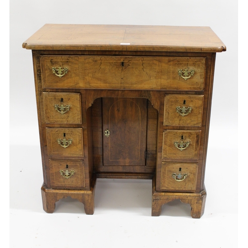 1735 - Early 18th Century walnut kneehole desk, the quarter veneered, crossbanded and line inlaid top with ... 