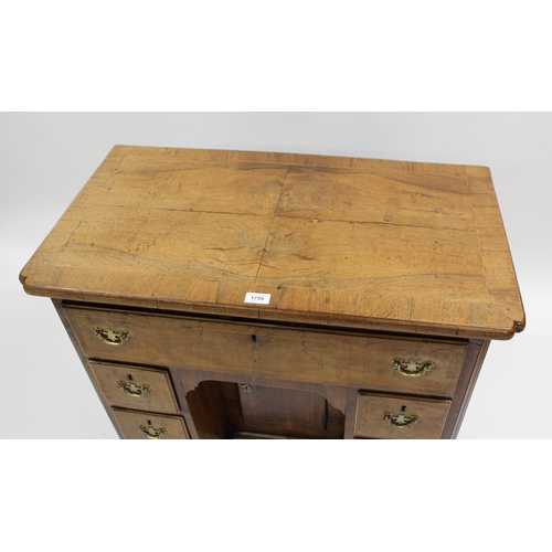 1735 - Early 18th Century walnut kneehole desk, the quarter veneered, crossbanded and line inlaid top with ... 