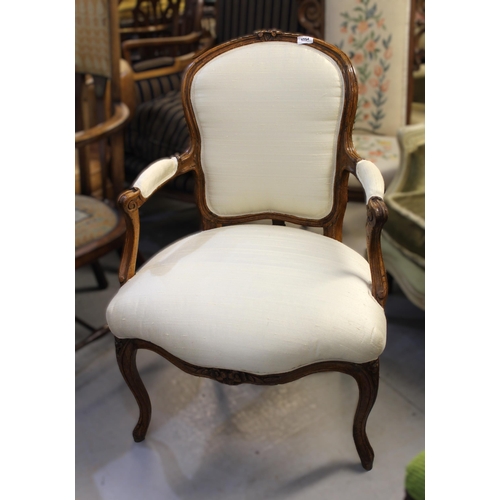 1754 - Pair of 19th Century French open arm chairs, newly upholstered i n a cream fabric, raised on carved ... 