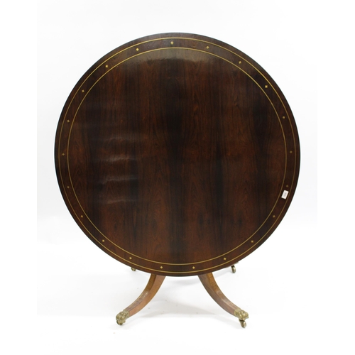 1856 - Regency circular rosewood and brass inlaid tilt top centre table, on turned column and four scroll s... 