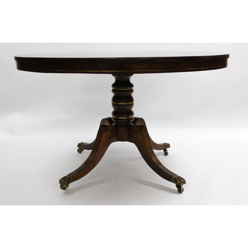 1856 - Regency circular rosewood and brass inlaid tilt top centre table, on turned column and four scroll s... 