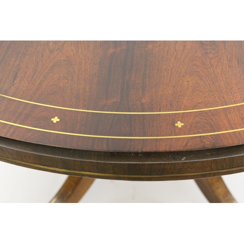 1856 - Regency circular rosewood and brass inlaid tilt top centre table, on turned column and four scroll s... 