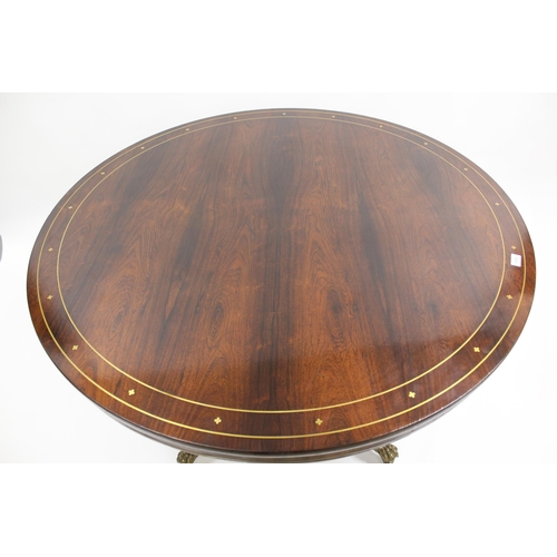 1856 - Regency circular rosewood and brass inlaid tilt top centre table, on turned column and four scroll s... 