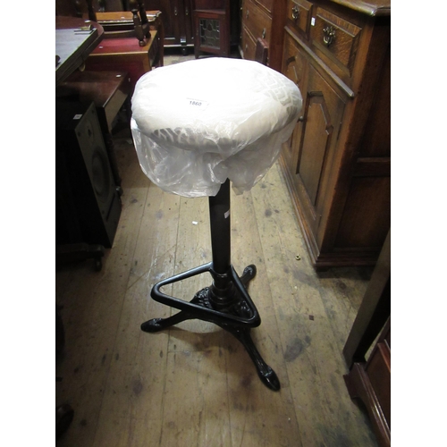 1860 - Modern cast iron circular stool with foot rest, together with a blue canvas travel trunk