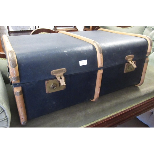 1860 - Modern cast iron circular stool with foot rest, together with a blue canvas travel trunk