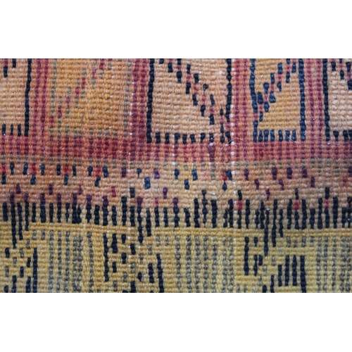 19 - Polychrome tribal rug, possibly Berber, with a triple medallion design and borders, 215 x 113cm