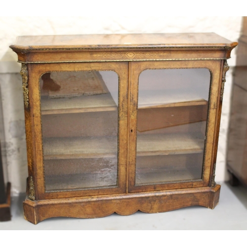 1915 - 19th Century burr walnut pier cabinet, having two glazed doors with two adjustable shelves, and gilt... 