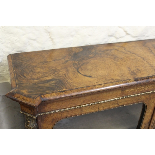 1915 - 19th Century burr walnut pier cabinet, having two glazed doors with two adjustable shelves, and gilt... 