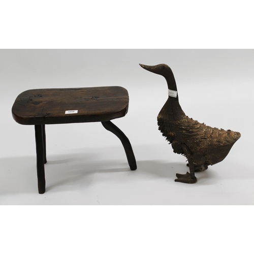 1959 - Primitive three legged stool with plank seat, 38cm wide, together with a primitive wooden figure of ... 