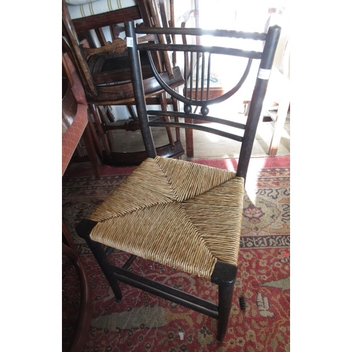 1966 - Arts and Crafts Sussex type ebonised side chair with rush seat, together with a 19th Century spindle... 