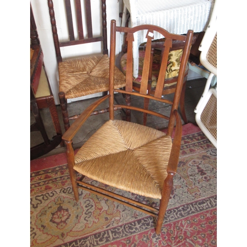 1994 - Arts & Crafts beechwood open arm chair with spindle back, together with various rush seated chairs, ... 