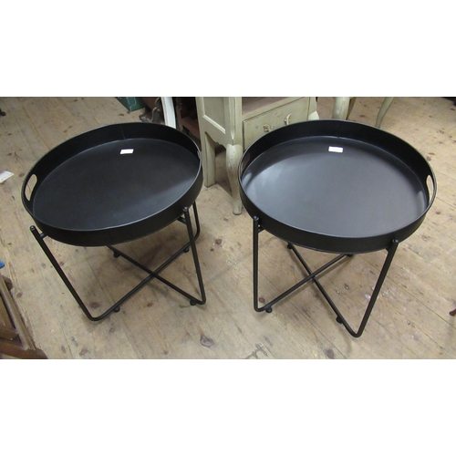 2016 - Pair of circular black metal lamp tables on folding bases