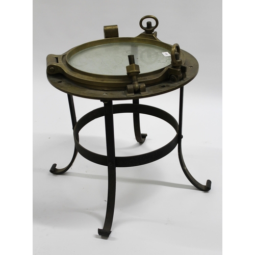 2023 - Large brass porthole cover adapted for use as an occasional table on a wrought iron stand, 50 x 60cm... 