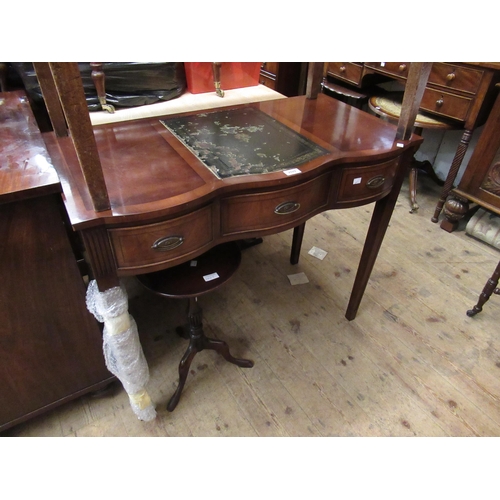 2029 - Reproduction mahogany serpentine fronted writing table with a crossbanded and leather inset top abov... 