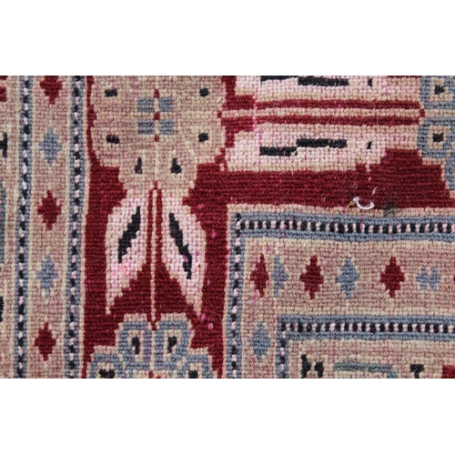 21 - Pakistan rug with a lobed medallion and plain design on a burgundy ground with borders, 255 x 158cm