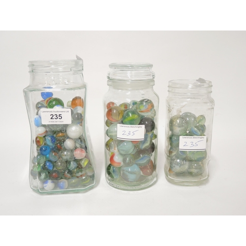 235 - Three glass jars containing a collection of various marbles