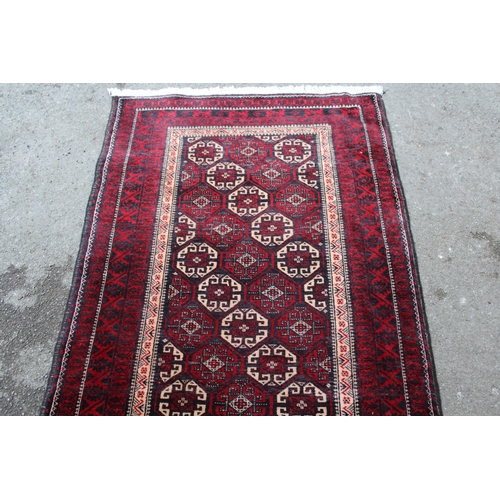 24 - Modern Belouch rug with an all-over hooked medallion design, in shades of ivory, red and dark blue, ... 