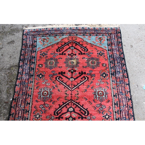 3 - Hamadan rug with an all-over stylised design on a pink ground with pale blue corner designs and bord... 