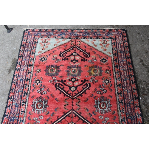 3 - Hamadan rug with an all-over stylised design on a pink ground with pale blue corner designs and bord... 