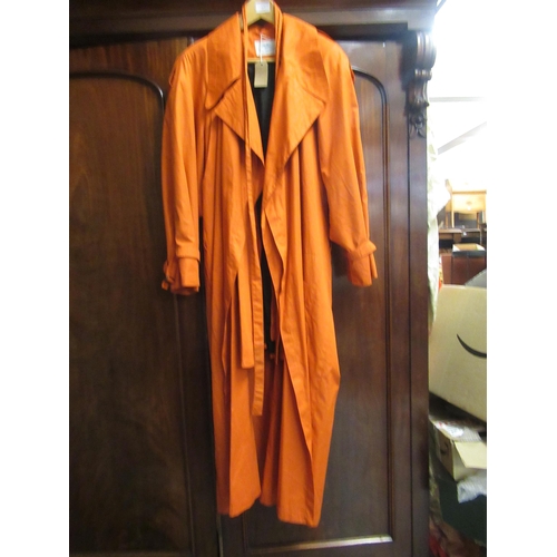 33 - Aquascutum paisley coat, together with a vintage orange raincoat by Wallis, size 14