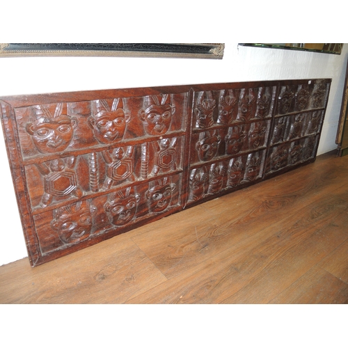 389 - Large East African carved hardwood wall panel, decorated with various faces, masks and animals, 50 x... 