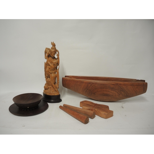 393 - Carved hardwood elongated bowl, (with two loose feet) and two wooden pestles, and a carved Asian fig... 