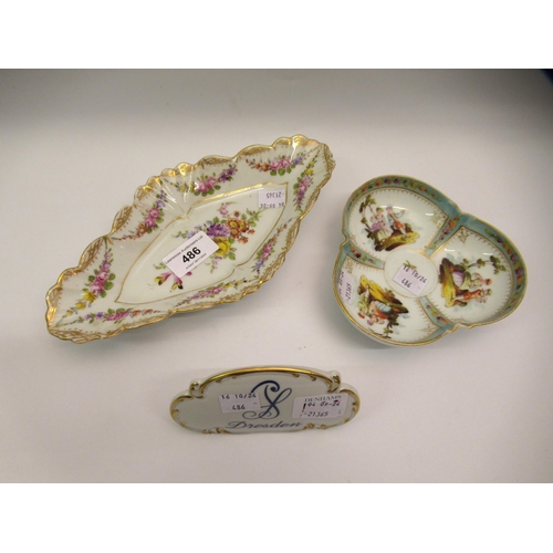 486 - Two Dresden floral and figural decorated dishes and a Dresden plaque