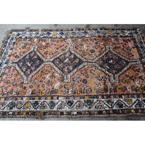 6 - Shiraz rug with three centre medallions, and multiple borders on red ground, 236 x 146cm