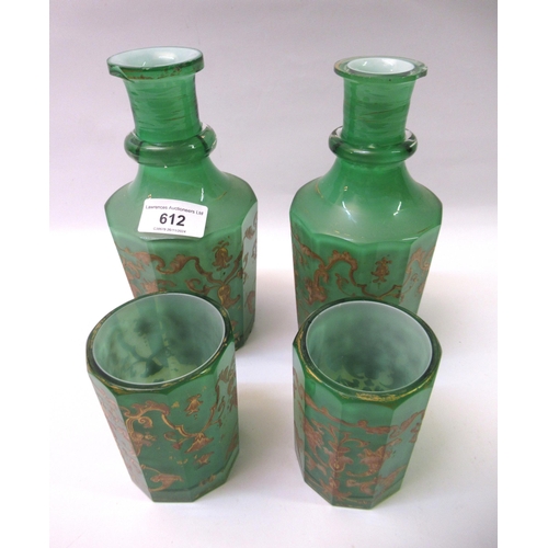 612 - Pair of 19th Century green overlaid white glass decanters with beakers (chips to rims)