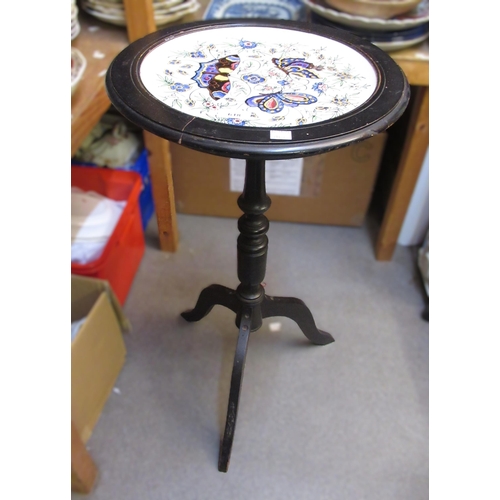 618 - 19th Century ebonised tripod wine table, the top inset with a circular pottery plate decorated with ... 