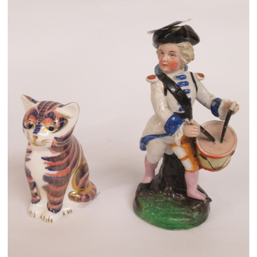 664 - Royal Crown Derby figure paperweight of a cat, together with a French porcelain figure of a boy drum... 