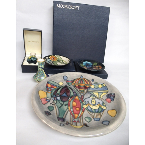 682 - Moorcroft plate decorated with air balloons, in original box, two smaller boxed Moorcroft plates, an... 