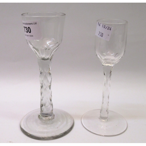 730 - 18th Century wine glass with faceted stem and bowl, 15cm high, together with a similar smaller wine ... 