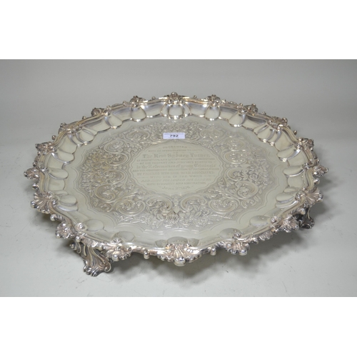 William IV Irish silver salver, the shaped rim enclosing a floral chased centre panel and engraved presentation central cartouche, raised on four pierced shaped supports, Dublin 1837, 91oz t (the presentation engraving dated 1876)