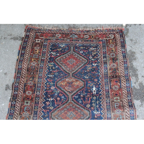 8 - Small South West Persian rug with a triple pole medallion on a midnight blue ground with subsidiary ... 