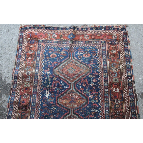 8 - Small South West Persian rug with a triple pole medallion on a midnight blue ground with subsidiary ... 