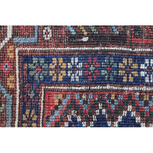 8 - Small South West Persian rug with a triple pole medallion on a midnight blue ground with subsidiary ... 