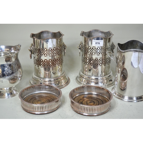 876 - Pair of plated bottle stands with lion ring handles, two other similar stands and a pair of plate on... 