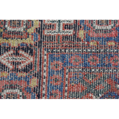 9 - Small Senneh rug with a triple medallion on a midnight blue ground with subsidiary Herati design and... 