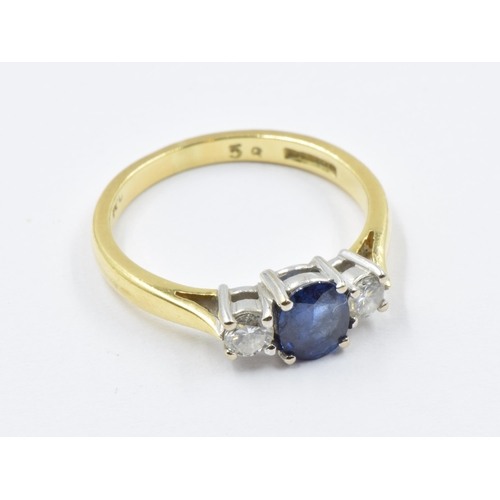 956 - 18ct Yellow gold ring set sapphire flanked by two diamonds, size K, 2.8g