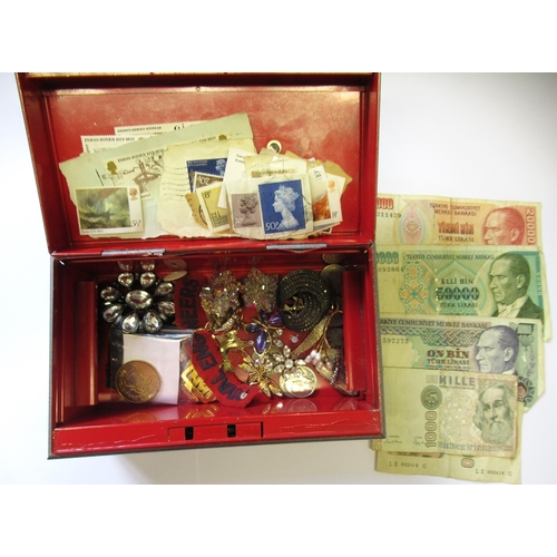 975 - Tin containing a quantity of sundry costume jewellery, coins, bank notes and stamps