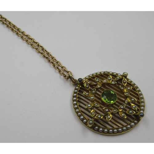 991 - Yellow gold peridot and split seed pearl set circular pendant on yellow metal chain