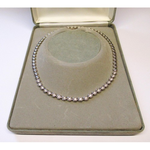 18ct White gold necklace set with twenty one diamonds, each approximately 4mm diameter, overall length 44.5cm, 52.5g